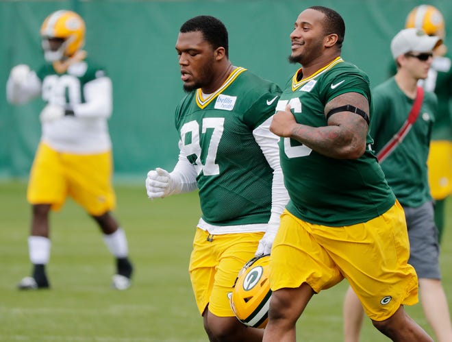 Green Bay Packers defensive end Mike Daniels (76) and nose tackle Kenny Clark (97) warmup during practice at Clarke Hinkle Field on Wednesday, May 29, 2019 in Ashwaubenon, Wis.