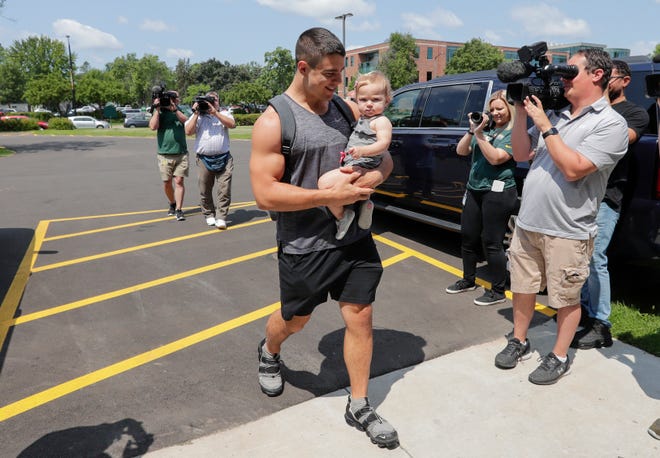 Packers linebacker Blake Martinez walks with his baby daughter Kinsley into Victor McCormick Hall at St. Norbert College as the team moves into the dorm for the start of training camp Tuesday, July 23, 2019, in De Pere, Wis.