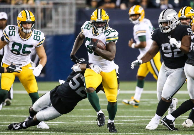 Aug 22, 2019; Winnipeg, Manitoba, CAN; Green Bay Packers running back Tra Carson (32) breaks away from Oakland Raiders middle linebacker Marquel Lee (52) during the third quarter at Investors Group Field.