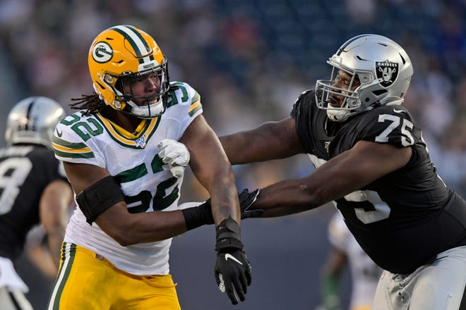 Aug 22, 2019; Winnipeg, Manitoba, CAN; Green Bay Packers linebacker Rashan Gary (52) battles against Oakland Raiders offensive tackle Brandon Parker (75) during the second half at Investors Group Field.