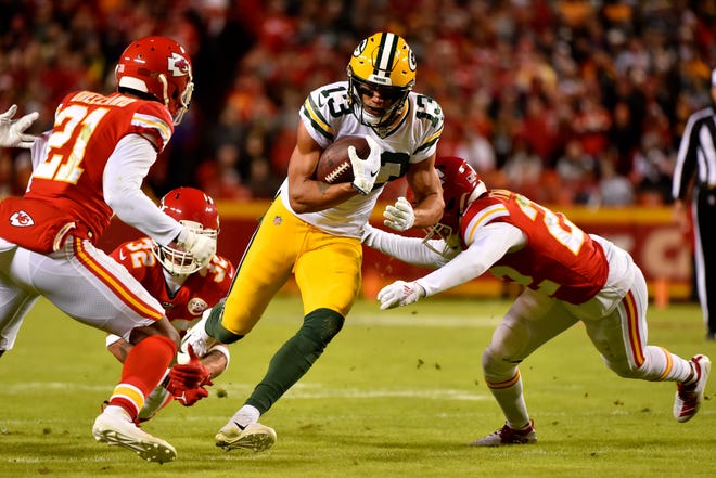 Green Bay Packers wide receiver Allen Lazard (13) carries the ball against Kansas City Chiefs cornerback Bashaud Breeland (21), safety Tyrann Mathieu (32) and safety Juan Thornhill (22), during the second half of an NFL football game in Kansas City, Mo., Sunday, Oct. 27, 2019.
