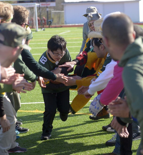 Ryo "Jom" Kato the Japanese Packers Cheering Team runs a gauntlet drill on Nov. 9, 2019 at Green Bay East High School.
