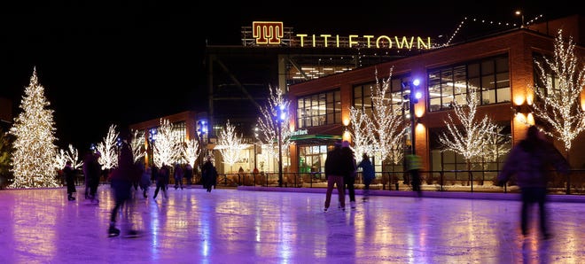 Ice skaters circle the rink at the Green Bay Packers' Titletown District across from Lambeau Field in January.
