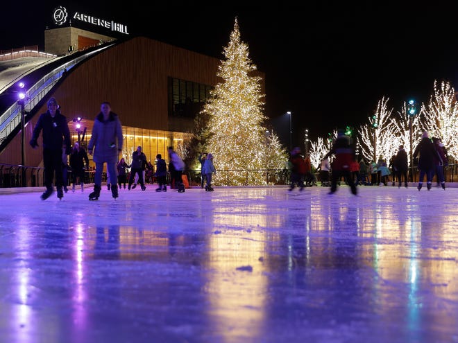 Ice skaters circle the rink at the Green Bay Packers' Titletown District on Jan. 2. The park's many trees stay lit all winter.