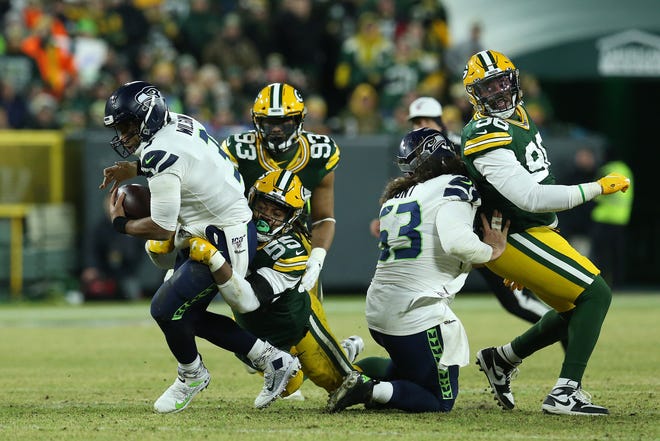 Russell Wilson #3 of the Seattle Seahawks is sacked by Za'Darius Smith #55 of the Green Bay Packers in the second quarter of  the NFC Divisional Playoff game at Lambeau Field on Sunday,  January 12, 2020 in Green Bay, Wis.