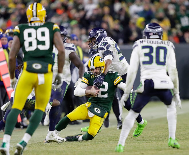 Green Bay Packers quarterback Aaron Rodgers (12) is brought down by Seattle Seahawks outside linebacker K.J. Wright (50) in the fourth quarter during their NFC divisional round playoff football game on Sunday, January 12, 2020, at Lambeau Field in Green Bay, Wis.
