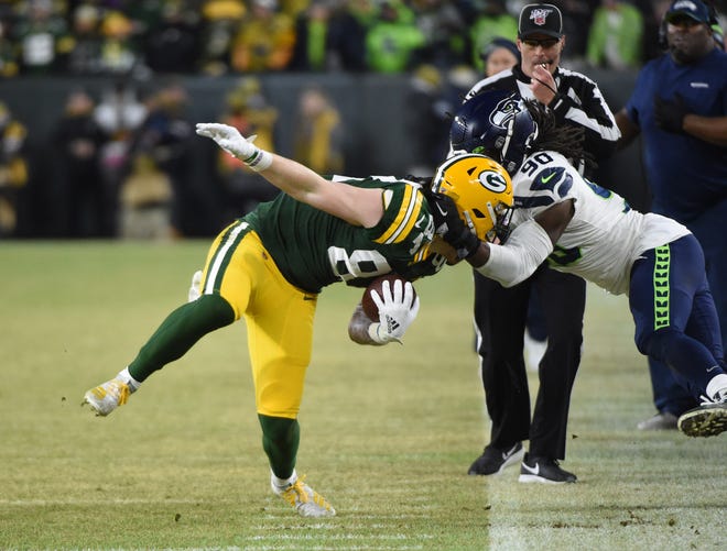 Green Bay Packers tight end Jace Sternberger (87) is tackled by Seattle Seahawks defensive tackle Jadeveon Clowney (90) in the second quarter of a NFC Divisional Round playoff football game at Lambeau Field on Sunday, January 12, 2020 in Green Bay, Wis.