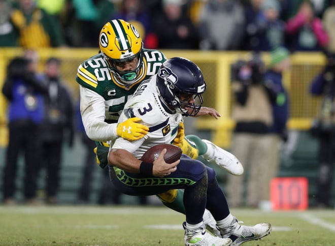 Seattle Seahawks quarterback Russell Wilson (3) is tackled by Green Bay Packers outside linebacker Za'Darius Smith (55) in the third quarter of a NFC Divisional Round playoff football game at Lambeau Field on January 12, 2020 in Green Bay, Wis.
