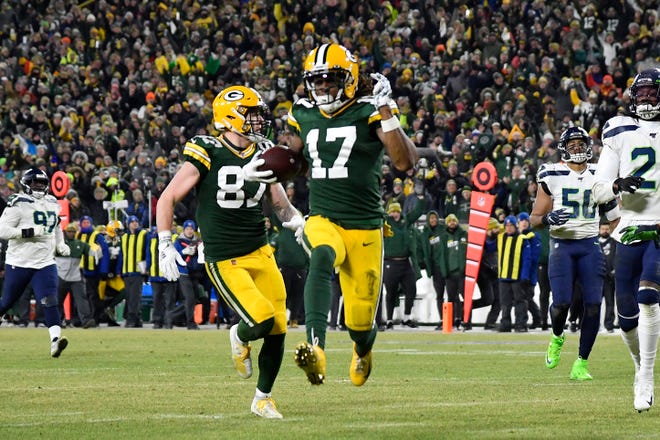Davante Adams #17 of the Green Bay Packers runs in a 40-yard touchdown catch against the Seattle Seahawks in the third quarter of the NFC Divisional Playoff game at Lambeau Field on January 12, 2020 in Green Bay, Wis.