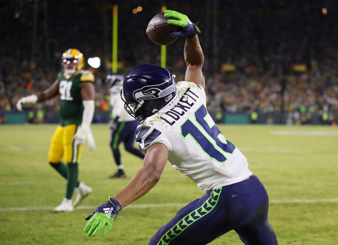 Tyler Lockett #16 of the Seattle Seahawks celebrates after scoring a touchdown during the third quarter against the Green Bay Packers in the NFC Divisional Playoff game at Lambeau Field on January 12, 2020 in Green Bay, Wis.