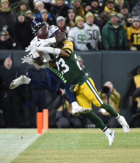 Green Bay Packers cornerback Jaire Alexander (23) breaks up a pass intended for Seattle Seahawks wide receiver D.K. Metcalf (14) in the first quarter of a NFC Divisional Round playoff football game at Lambeau Field on Sunday, January 12, 2020 in Green Bay, Wis.