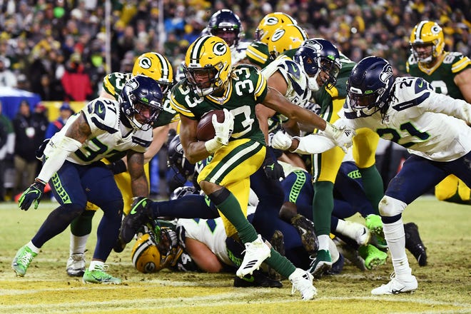 Aaron Jones #33 of the Green Bay Packers rushes for a touchdown during the second quarter against the Seattle Seahawks in the NFC Divisional Playoff game at Lambeau Field on January 12, 2020 in Green Bay, Wis.
