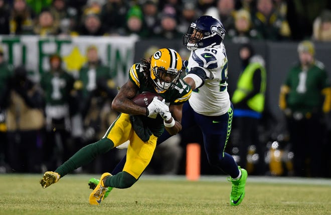 Davante Adams #17 of the Green Bay Packers gets a first down against K.J. Wright #50 of the Seattle Seahawks during the first quarter of the NFC Divisional Playoff game at Lambeau Field on Sunday, January 12, 2020 in Green Bay, Wis.