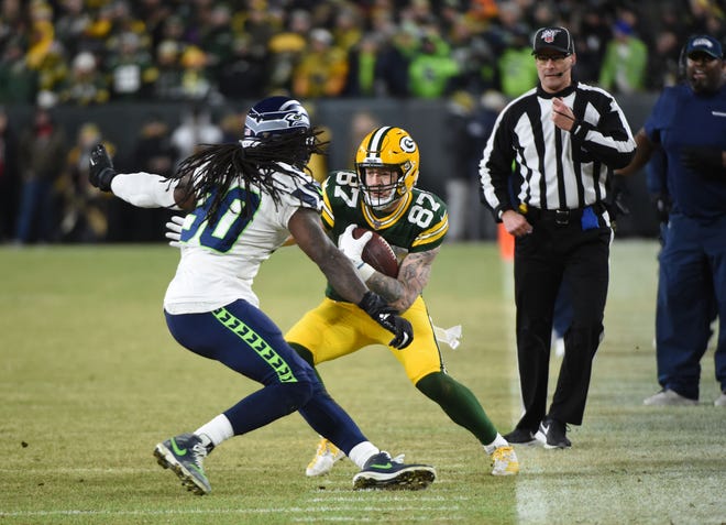 Green Bay Packers tight end Jace Sternberger (87) runs against Seattle Seahawks defensive end Jadeveon Clowney (90) in the second quarter of a NFC Divisional Round playoff football game at Lambeau Field on Sunday, January 12, 2020 in Green Bay, Wis.
