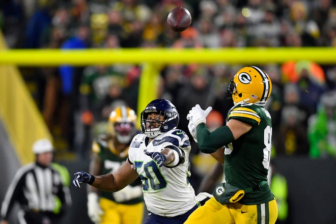 Jimmy Graham #80 of the Green Bay Packers makes a catch against K.J. Wright #50 of the Seattle Seahawks in the third quarter of the NFC Divisional Playoff game at Lambeau Field on January 12, 2020 in Green Bay, Wisconsin.