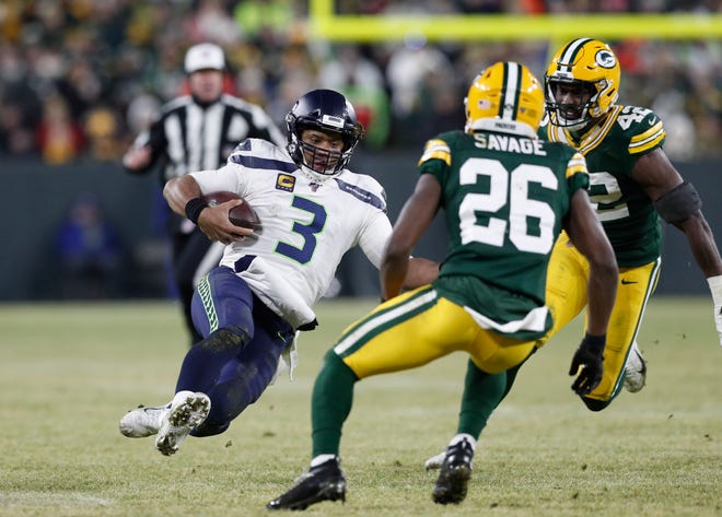 Seattle Seahawks quarterback Russell Wilson (3) slides against the Green Bay Packers in the third quarter of a NFC Divisional Round playoff football game at Lambeau Field on January 12, 2020 in Green Bay, Wis.