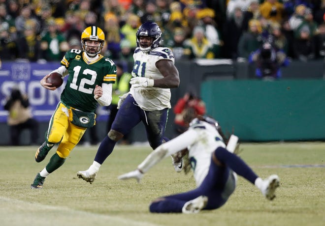 Green Bay Packers quarterback Aaron Rodgers (12) runs the ball against the Seattle Seahawks in the fourth quarter of a NFC Divisional Round playoff football game on Sunday, January 12, 2020, at Lambeau Field in Green Bay, Wis.