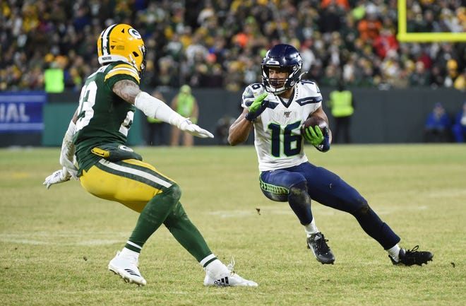Seattle Seahawks wide receiver Tyler Lockett (16) runs the ball against Green Bay Packers cornerback Jaire Alexander (23) in the third quarter of a NFC Divisional Round playoff football game on Sunday, January 12, 2020, at Lambeau Field in Green Bay, Wis.