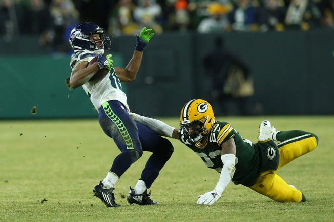 Tyler Lockett #16 of the Seattle Seahawks runs the ball against Jaire Alexander #23 of the Green Bay Packers in the fourth quarter of the NFC Divisional Playoff game at Lambeau Field on January 12, 2020 in Green Bay, Wisconsin.