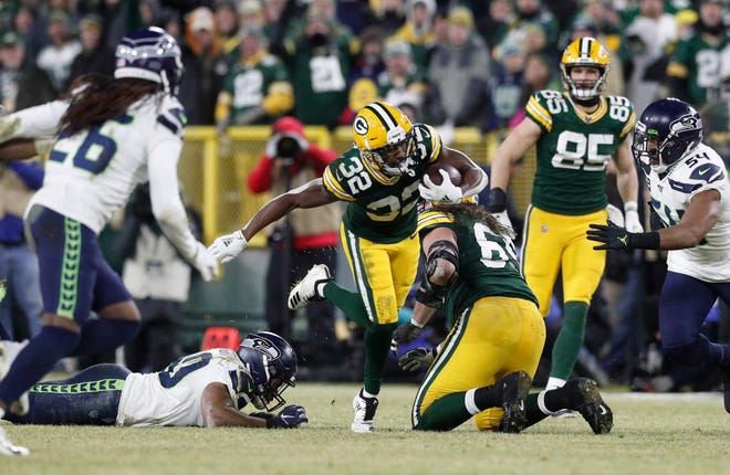 Green Bay Packers running back Tyler Ervin (32) runs the ball against the Seattle Seahawks in the second quarter of a NFC Divisional Round playoff football game at Lambeau Field on Sunday, January 12, 2020 in Green Bay, Wis.