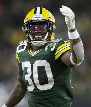 Green Bay Packers running back Jamaal Williams (30) is all smiles at the start of the second half against the Seattle Seahawks during their NFC divisional round playoff football game Sunday, January 12, 2020, at Lambeau Field in Green Bay, Wis.