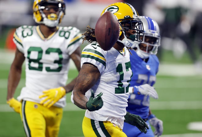 Davante Adams #17 of the Green Bay Packers celebrates scoring a 56-yard receiving touchdown during the first quarter against the Detroit Lions at Ford Field on December 13, 2020 in Detroit, Michigan.