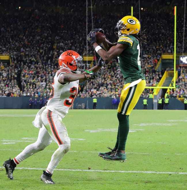 Green Bay Packers wide receiver Davante Adams (17) catches a one-yard touchdown pass while being covered by Cleveland Browns safety Jovante Moffatt (35) quarter of their game Saturday, December 25, 2021 at Lambeau Field in Green Bay, Wis.